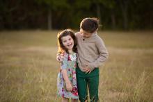 Colorful image of brother and sister in a field in Colleyville Texas