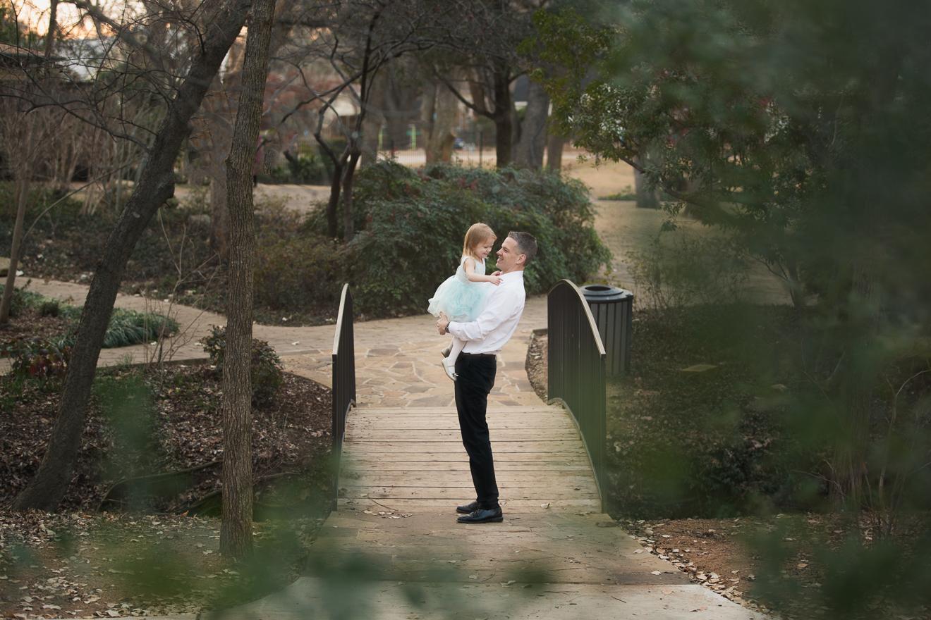 Beautiful outdoor image of father and baby daughter on a bridge near Grapevine Flower Mound Southlake Dallas Texas 