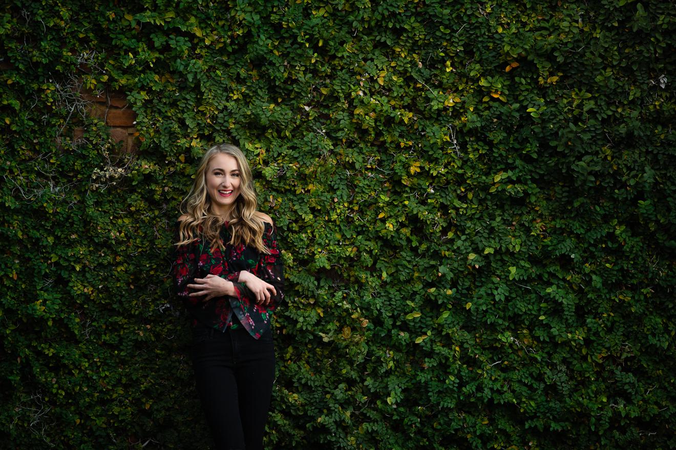 Elegant photo of graduating senior girl with ivy covered wall background in Trophy Club Southlake Texas