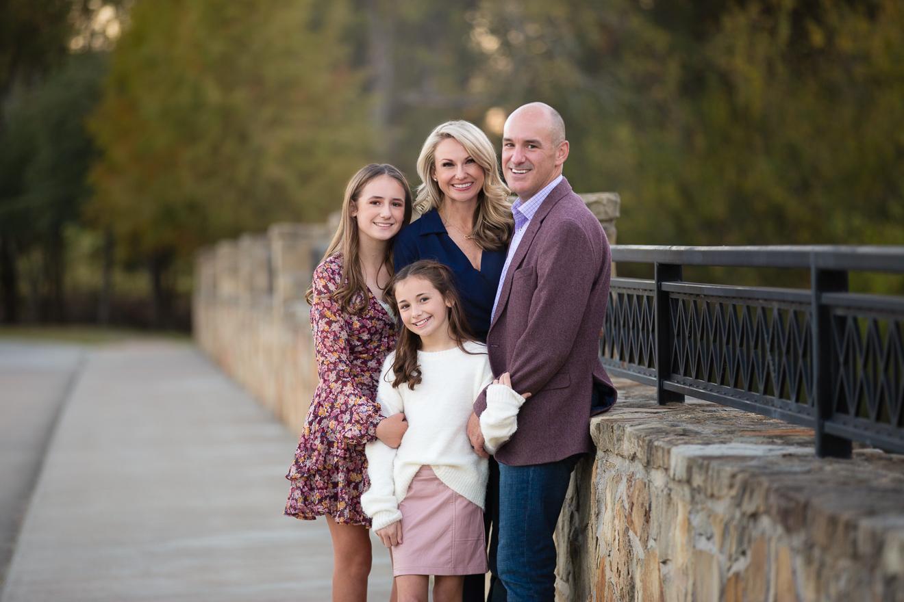 Beautiful color portrait of family on a bridge in Southlake Texas by Trophy Club best family photographer