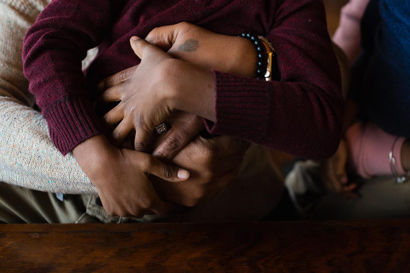 Colorful photograph of hands clasped in a hug by Roanoke Southlake Trophy Club family photographer