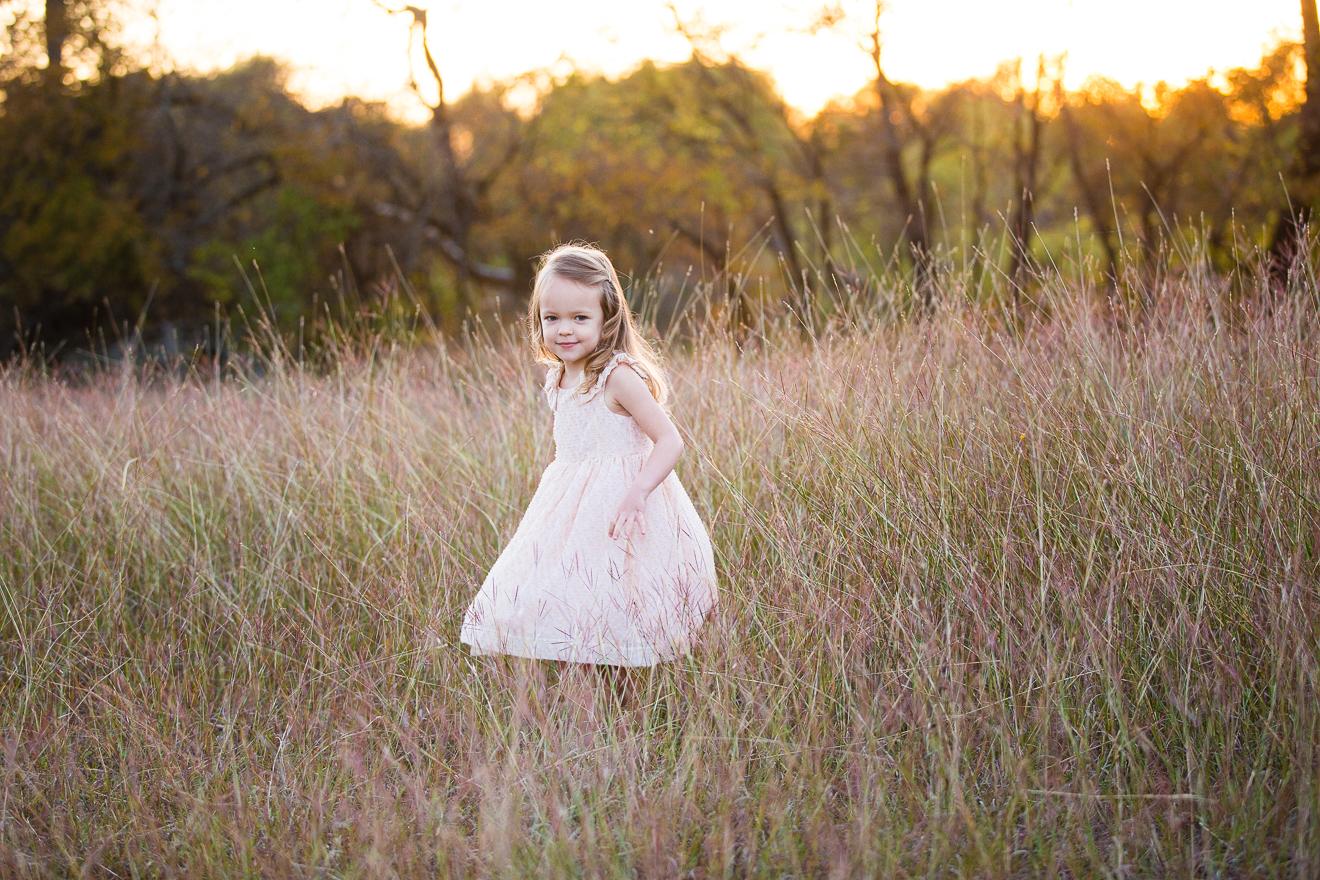 Little girl in a field with beautiful light near Trophy Club Texas