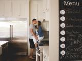Parents kissing in their kitchen by photographer Sunny Mays near Westlake Texas