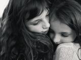 Close up black and white image of Sisters hugging near Trophy Club Texas