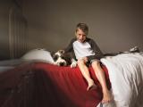  Boy petting his dog on bed metro Dallas Ft Worth by Sunny Mays 