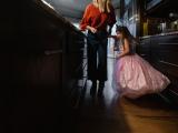 Dark Colorful image of a little girl princess dancing in her kitchen